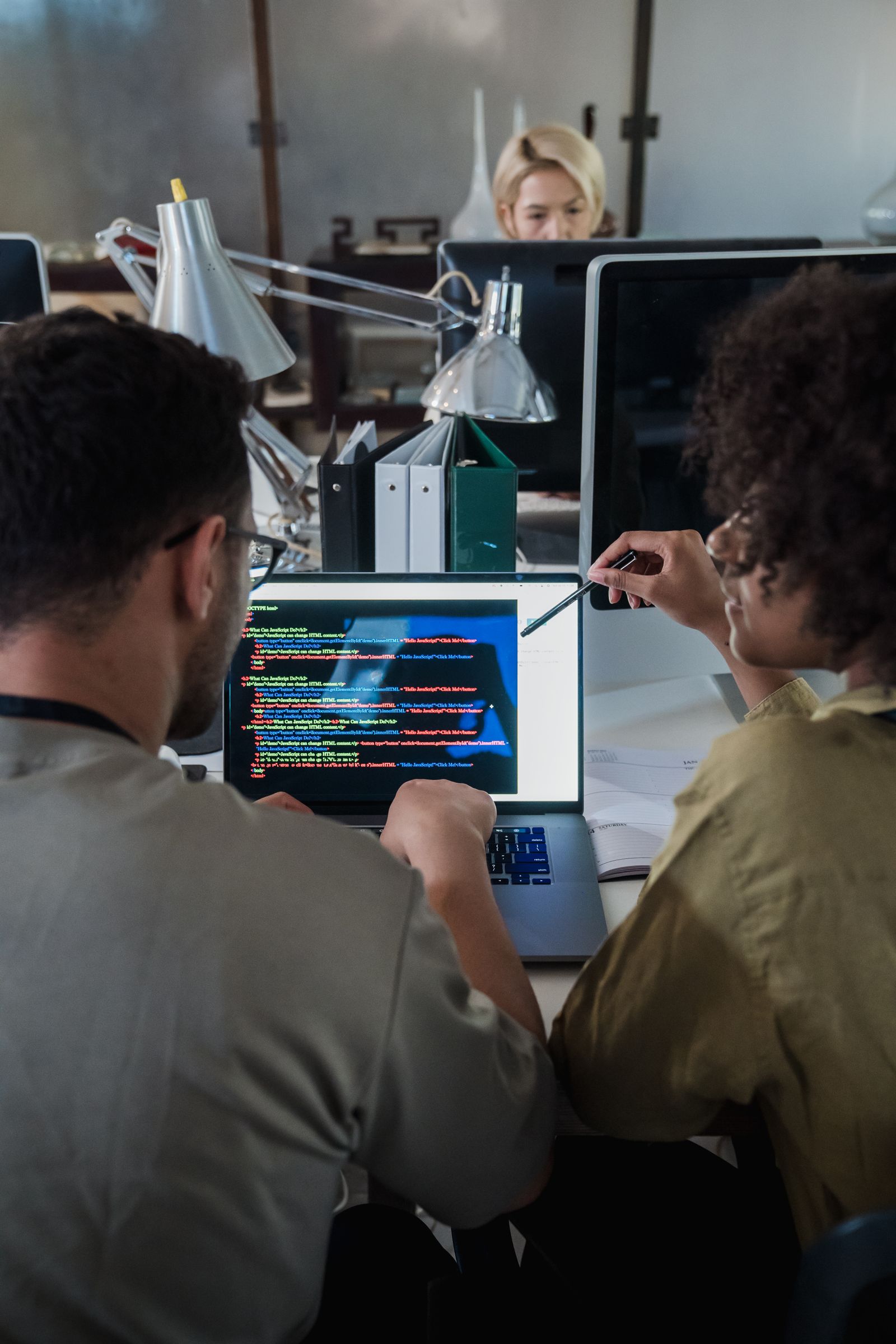 Two software professionals working together at a laptop